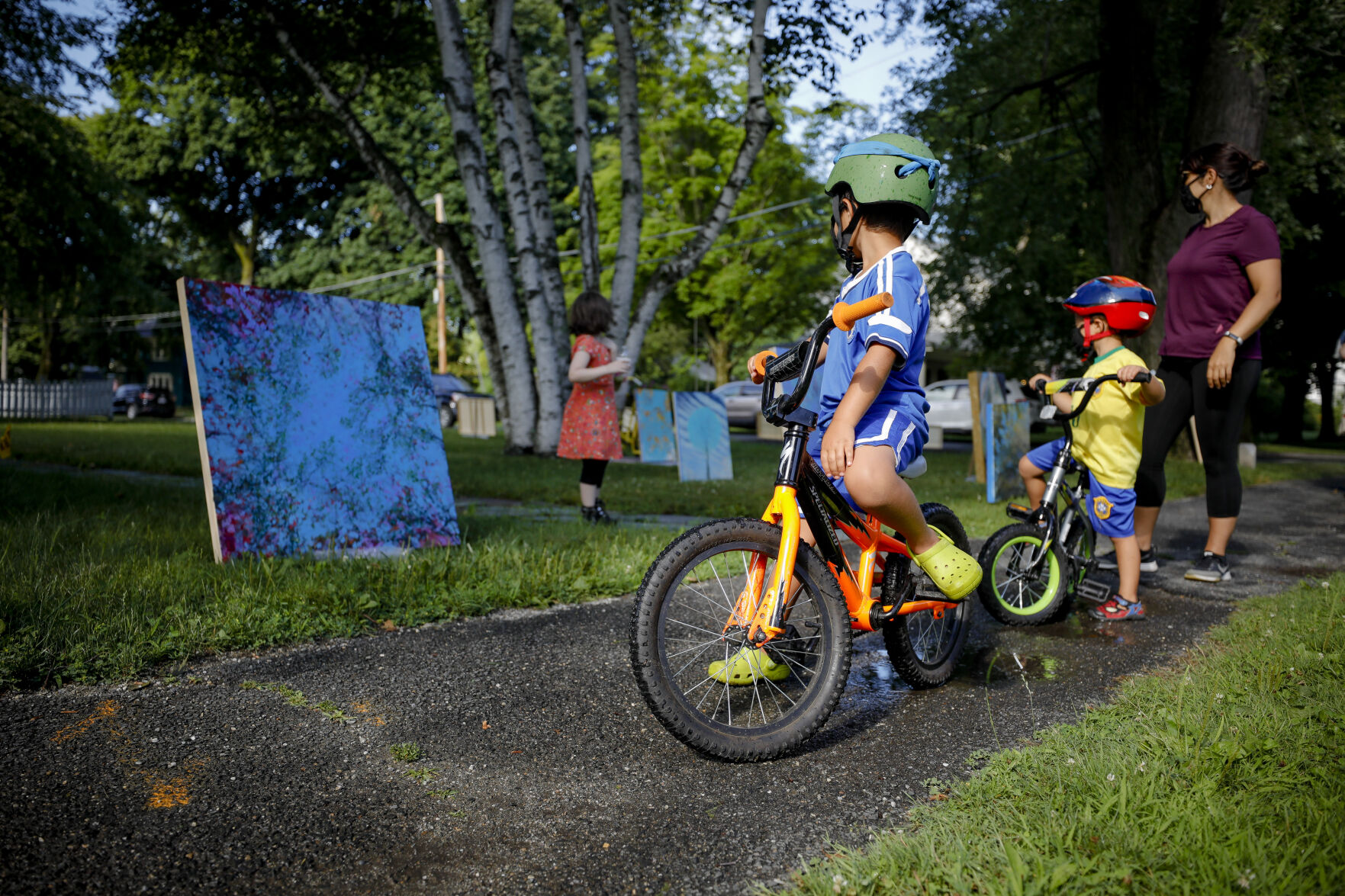 Kids on bikes look at art